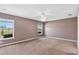 Large primary bedroom featuring neutral paint, carpet, and a view of the yard at 36455 Clara St, Eustis, FL 32736