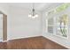 Dining room with chandelier, window with natural light, and hardwood floors at 36455 Clara St, Eustis, FL 32736