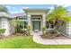 Front entrance with beautiful tropical landscaping at 36455 Clara St, Eustis, FL 32736