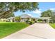 Well-maintained home features a spacious driveway and covered parking at 36455 Clara St, Eustis, FL 32736
