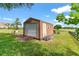 Exterior view of the outbuilding with a garage door and side access at 36455 Clara St, Eustis, FL 32736