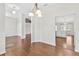 Hallway with hardwood floors leading to the kitchen and living areas of the home at 36455 Clara St, Eustis, FL 32736