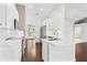 Open concept kitchen with white cabinets, stainless steel appliances, and quartz countertops at 36455 Clara St, Eustis, FL 32736