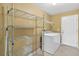 Bright laundry room with washer, dryer, metal shelving, and tile floor at 36455 Clara St, Eustis, FL 32736