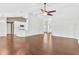 Open concept living area featuring hardwood floors, vaulted ceiling, and kitchen view at 36455 Clara St, Eustis, FL 32736
