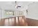 Spacious living room with hardwood floors, fan, recessed lights and view of the backyard and pool at 36455 Clara St, Eustis, FL 32736