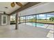 Spacious screened patio with ceiling fans and a view of the pool and golf course at 36455 Clara St, Eustis, FL 32736