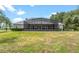 Backyard with a large, screened pool, with a well-kept lawn at 36455 Clara St, Eustis, FL 32736