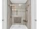 Modern shower with glass doors, tiled walls, and built-in bench at 36455 Clara St, Eustis, FL 32736