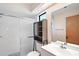 Bathroom with glass-enclosed shower, decorative tile, and vanity with mirror at 36482 Doral Dr, Grand Island, FL 32735