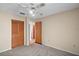 Bedroom with a ceiling fan, closet, and an entrance to the bathroom at 36482 Doral Dr, Grand Island, FL 32735