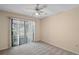 Bedroom with a ceiling fan and sliding doors to the screened porch at 36482 Doral Dr, Grand Island, FL 32735