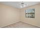 Bedroom with ceiling fan and window overlooking the front yard at 36482 Doral Dr, Grand Island, FL 32735