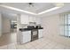 A partial view of the kitchen with appliances and access to a bright living room at 36482 Doral Dr, Grand Island, FL 32735
