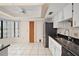 The kitchen has a double stainless steel sink with white cabinets and tile flooring at 36482 Doral Dr, Grand Island, FL 32735