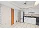 Updated kitchen featuring stainless steel appliances, black countertops, and white cabinets at 36482 Doral Dr, Grand Island, FL 32735