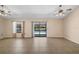 A spacious living room with a sliding door leading to the pool is cooled with two ceiling fans at 36482 Doral Dr, Grand Island, FL 32735