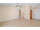 A spacious living room with neutral paint and tiled flooring showcases a ceiling fan and closet at 36482 Doral Dr, Grand Island, FL 32735