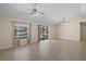 A large living room with multiple ceiling fans has access to the pool area at 36482 Doral Dr, Grand Island, FL 32735