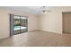 The living room has access to the pool area via a sliding glass door with neutral colored walls at 36482 Doral Dr, Grand Island, FL 32735