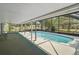A serene screened-in pool with covered seating area, perfect for enjoying the outdoors year-round at 36482 Doral Dr, Grand Island, FL 32735
