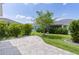 Backyard with brick patio, landscaping and view of adjacent home at 3745 Causey Ct, The Villages, FL 32163