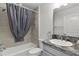 Full bathroom features shower-tub combination, single vanity with gray cabinets, and tile surround at 3745 Causey Ct, The Villages, FL 32163