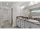 Bright bathroom featuring double vanity, neutral color scheme, and a separate shower room at 3745 Causey Ct, The Villages, FL 32163
