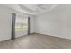 A bright bedroom with tray ceiling, hardwood floors, and natural light at 3745 Causey Ct, The Villages, FL 32163