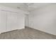 Bright bedroom features vinyl flooring, fan, and a closet for convenient storage at 3745 Causey Ct, The Villages, FL 32163