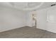 An empty bedroom with tray ceilings, hardwood floors, and ensuite bathroom at 3745 Causey Ct, The Villages, FL 32163