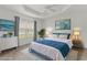 Staged bedroom featuring hardwood floors, dresser, bed, and ocean themed decor at 3745 Causey Ct, The Villages, FL 32163