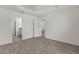 Empty bedroom showing the open door to an ensuite bathroom and hardwood floors at 3745 Causey Ct, The Villages, FL 32163