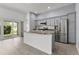 Modern kitchen with stainless steel appliances, granite countertops, and an island with seating at 3745 Causey Ct, The Villages, FL 32163