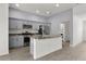 Bright kitchen with stainless steel appliances, center island and easy access to the laundry room at 3745 Causey Ct, The Villages, FL 32163