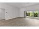 Living room with sleek vinyl flooring, fan, recessed lighting, and sliding glass doors to the backyard at 3745 Causey Ct, The Villages, FL 32163