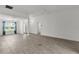 Large living room showcasing the front entrance, dining area, and hardwood floors at 3745 Causey Ct, The Villages, FL 32163