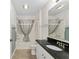 Clean bathroom with a shower, granite countertop, and a large mirror at 403 Duarte Ln, The Villages, FL 32159