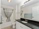 Bright bathroom featuring a bathtub with shower, granite countertop, and modern fixtures at 403 Duarte Ln, The Villages, FL 32159