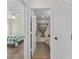 Bathroom featuring a shower with patterned curtain and an adjacent bedroom at 403 Duarte Ln, The Villages, FL 32159