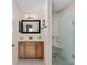 This bathroom includes a glass-door shower and a vanity with drawers for storage at 403 Duarte Ln, The Villages, FL 32159