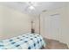 Clean bedroom featuring a ceiling fan, and a closet with sliding doors at 403 Duarte Ln, The Villages, FL 32159