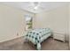 Comfortable bedroom with a quilt-covered bed, a ceiling fan, and a window view at 403 Duarte Ln, The Villages, FL 32159