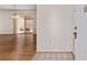 A glimpse of the living room with light tile leading to wood floors with access to an outdoor patio at 403 Duarte Ln, The Villages, FL 32159