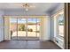 This enclosed patio features tile floors, a ceiling fan, and a sliding glass door to the backyard at 403 Duarte Ln, The Villages, FL 32159