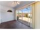 This enclosed patio includes a sliding glass door, a ceiling fan, and access to the backyard area at 403 Duarte Ln, The Villages, FL 32159