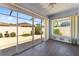 This enclosed patio includes a sliding glass door, a window, and views of the backyard area at 403 Duarte Ln, The Villages, FL 32159