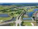 Breathtaking aerial view of a lush golf course community with multiple water features and walking trails at 503 Vigo St, Davenport, FL 33837