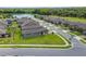 An aerial shot of a residential neighborhood, highlighting the neatly planned layout and serene pond at 503 Vigo St, Davenport, FL 33837