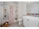 Bathroom with white cabinets and white shower-tub combination at 503 Vigo St, Davenport, FL 33837